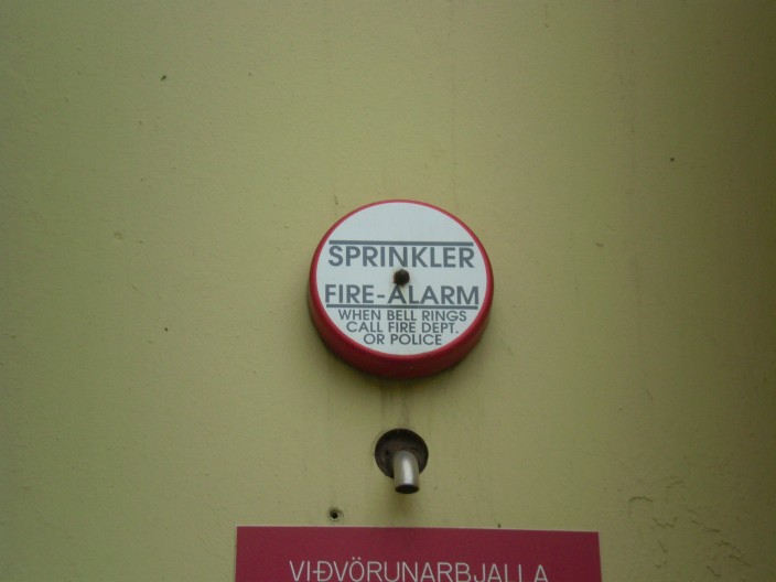 A sign reading “When alarm sounds, call fire department or police”